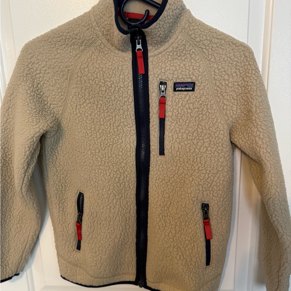 Patagonia Kids Beige Fleece Jacket with Red Accents. Gently used. Fits boys 8-10